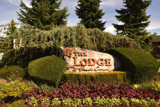 The Lodge at Peasley Canyon stone sign, greenery