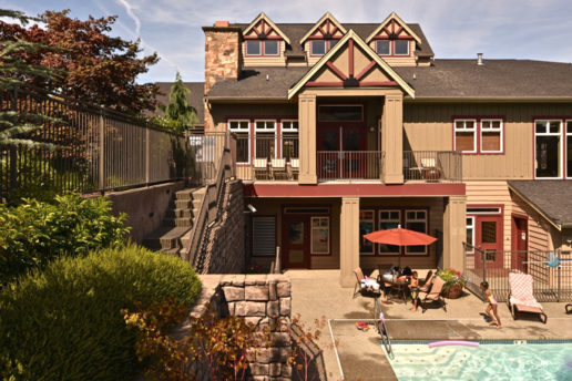 Exterior of building, swimming pool with lounge chairs and family enjoying sun