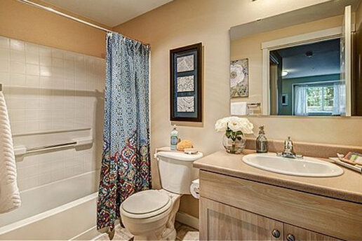 Neutral beige bathroom with decor, bathtub and shower