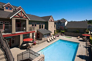 Federal Way WA Apartments - The Lodge At Peasley Canyon - Lounge Seating surrounds gated Pool Facing Club House?'?