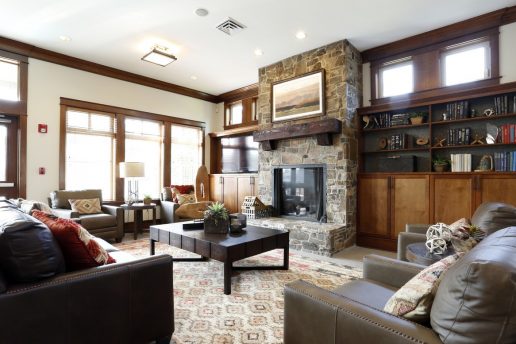 lodge room with fireplace, sitting areas, book shelves