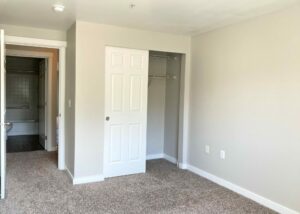 Unit Closet, Sliding door, carpet flooring, bedroom across from bathroom.