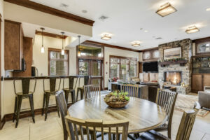 Rustic Community Clubhouse Kitchen area with breakfast bar, 6 seat tables, Open floor plan, Community lounge area near kitchen.