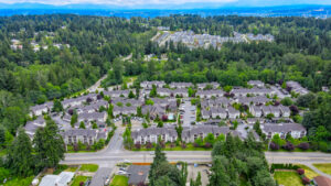 Aerial Exterior of Lodge at peasley canyon community, surrounding areas in shot, dense woods in background.